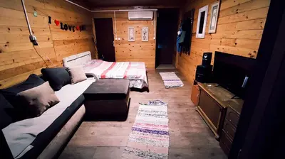 a room with a bed and a couch and a tv at Sidro river house in Ulcinj
