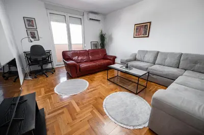 a living room with a couch and a table at Sky Center Apartment in Podgorica