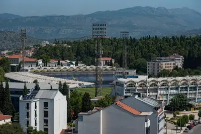 an overhead view of a city with a river and buildings at Sky Center Apartment in Podgorica