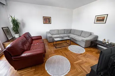 a living room with a couch and a table at Sky Center Apartment in Podgorica