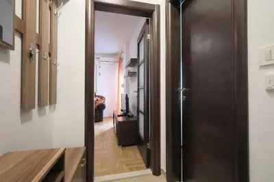 a hallway with a door leading into a room at Status-M Apartments Rozino in Budva