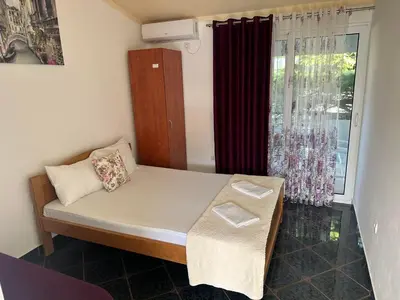 a small bedroom with a bed and a window at Apartmani Resetar 2 in Brca