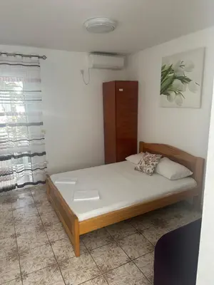 a bedroom with a bed in a room at Apartmani Resetar 2 in Brca