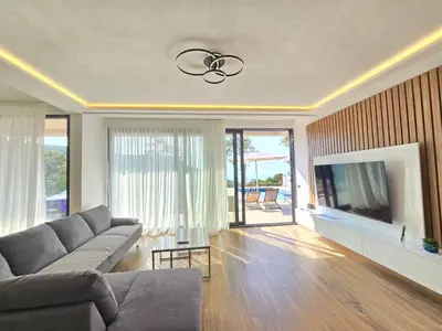 a living room with a couch and a flat screen tv at Villa LuceSole Budva in Budva