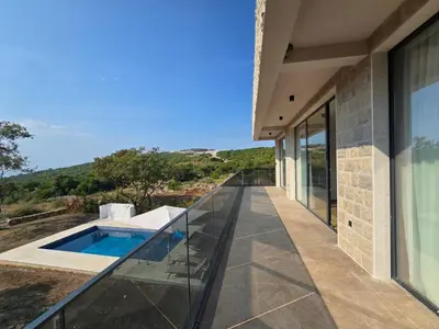 a balcony of a house with a swimming pool at Villa LuceSole Budva in Budva