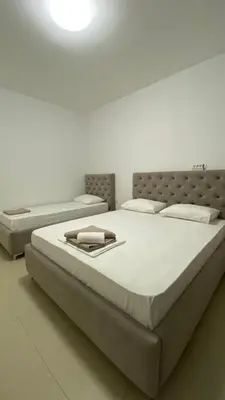 a large bed in a room with two mattresses at Apartments Drini in Ulcinj