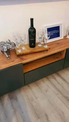 a bottle of wine and glasses on a wooden counter at Apartman Skadarsko jezero bay in Vranjina