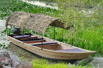 a small wooden boat with a straw roof at Apartman Skadarsko jezero bay in Vranjina