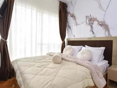 a bedroom with a large bed with pillows on it at Luxury apartment with 2 rooms in hotel Tre canne in Budva
