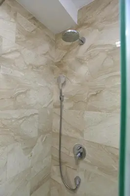 a shower with a shower head in a bathroom at Luxury apartment with 2 rooms in hotel Tre canne in Budva