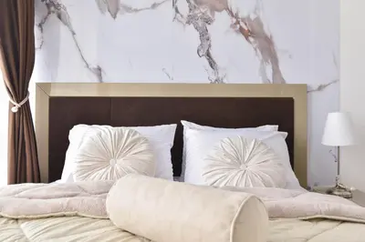 a bedroom with a large bed with white pillows at Luxury apartment with 2 rooms in hotel Tre canne in Budva