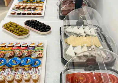 a white table topped with lots of different types of food at Appartment Do and Pool in Ulcinj