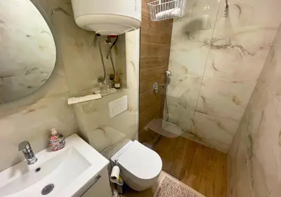 a bathroom with a toilet and a sink and a shower at Appartment Do and Pool in Ulcinj