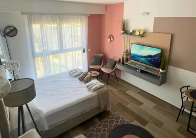 a bedroom with a large bed and a flat screen tv at Appartment Do and Pool in Ulcinj