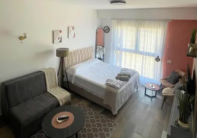 a small bedroom with a bed and a couch at Appartment Do and Pool in Ulcinj