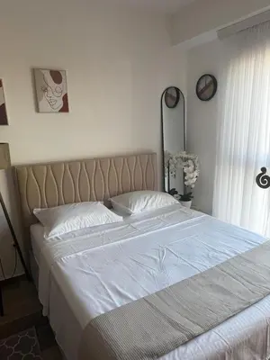 a bedroom with a large bed with white sheets at Appartment Do and Pool in Ulcinj