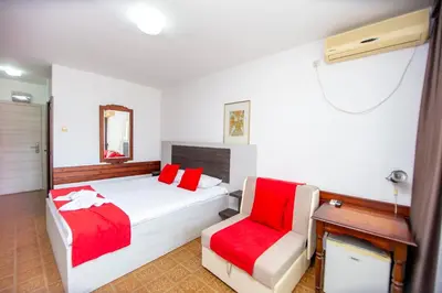 a hotel room with a bed and a chair at Apartments Palma in Budva