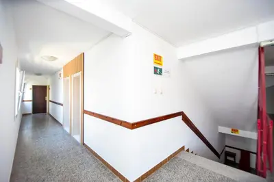 a hallway with white walls and a stair case at Apartments Palma in Budva