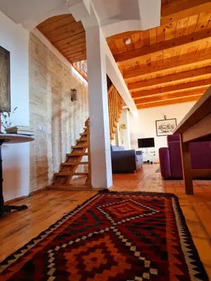 a living room with a staircase and a rug at Stonehouse Mimi in Lapčići