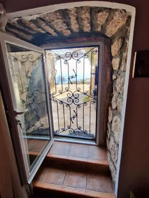 an open door to a balcony with a gate at Stonehouse Mimi in Lapčići