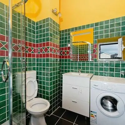 a green tiled bathroom with a toilet and a sink at Stonehouse Mimi in Lapčići