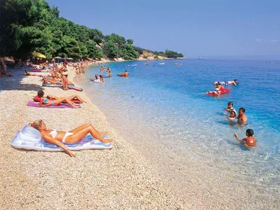 a group of people laying on a beach at Montebar2 in Brca