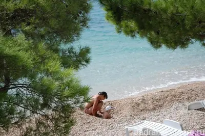 a woman playing in the sand at the beach at Montebar2 in Brca