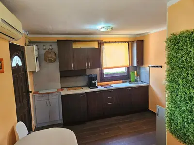 a small kitchen with wooden cabinets and a window at Montebar2 in Brca