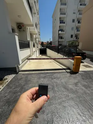 a person holding a cell phone in front of a building at Deluxe Studio Apartment with Sea View in Bar