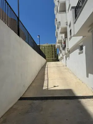 an empty alleyway between two buildings with a fence at Deluxe Studio Apartment with Sea View in Bar