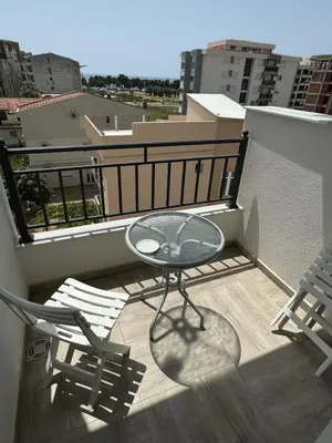 a balcony with a glass table and two chairs at Deluxe Studio Apartment with Sea View in Bar