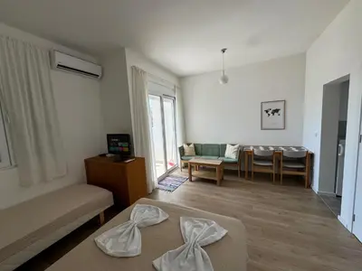 a living room with a couch and a table at Deluxe Studio Apartment with Sea View in Bar