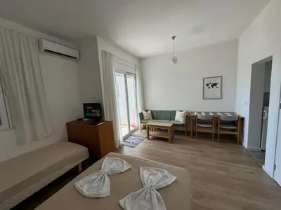 a living room with a couch and a table at Deluxe Studio Apartment with Sea View in Bar