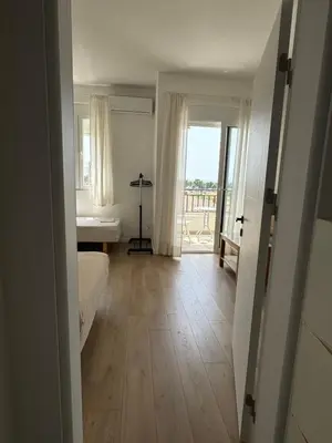 a room with a hallway with a floor to ceiling window at Deluxe Studio Apartment with Sea View in Bar