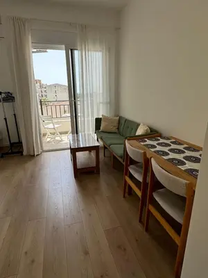 a living room with a couch and a table at Deluxe Studio Apartment with Sea View in Bar
