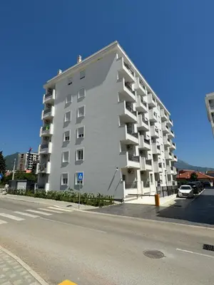 a large white apartment building on the side of a street at Deluxe Studio Apartment with Sea View in Bar