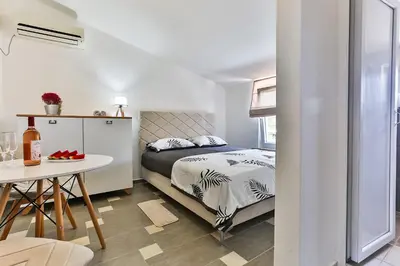 a small bedroom with a bed and a table at Shanti apartments in Bar