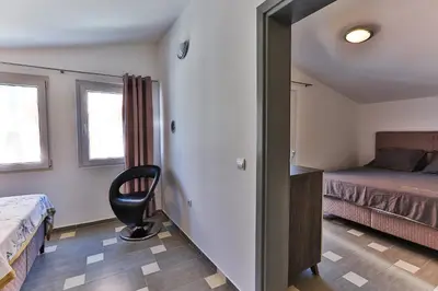 a bedroom with a bed and a desk and a chair at Shanti apartments in Bar