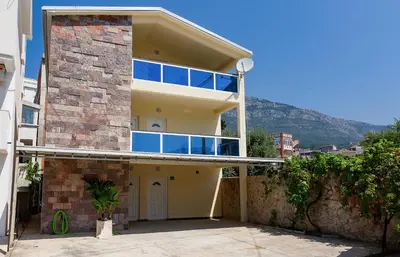 a large building with a balcony on top of it at Shanti apartments in Bar
