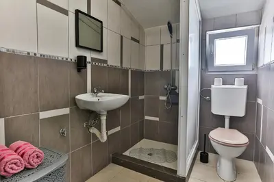 a bathroom with a toilet and a sink at Shanti apartments in Bar