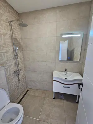 a bathroom with a sink and a toilet at La Vida Apartments in Babalonija