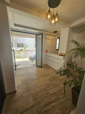 an office with a hallway with a door and a plant at La Vida Apartments in Babalonija
