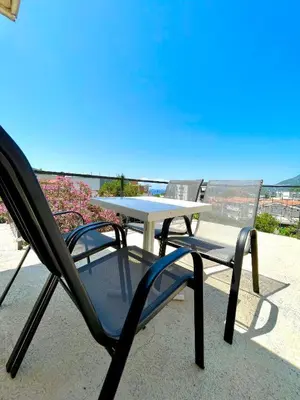 a table and chairs sitting on a patio at KAP Apartments in Sutomore