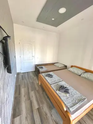 a room with two beds and a tv in it at KAP Apartments in Sutomore