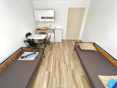 a room with two trampolines and a table and a kitchen at KAP Apartments in Sutomore