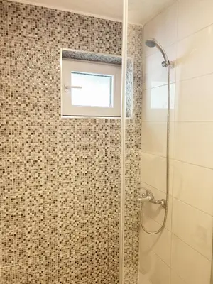 a bathroom with a shower and a window at Zinzula 1 in Bar