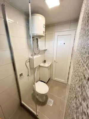 a bathroom with a toilet and a shower at Zinzula 1 in Bar