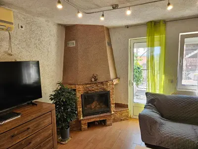 a living room with a fireplace and a television at Montebar1 in Bar