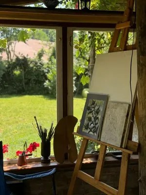a painting on an easel next to a window at Artistic Garden House in Cetinje