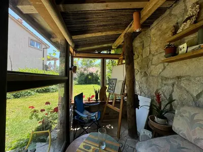 a room with a table and a stone wall at Artistic Garden House in Cetinje